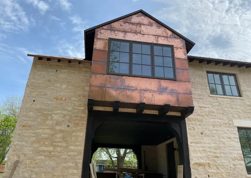 Copper metal panel facade on a stone building for Metal Roof Coating in Godley