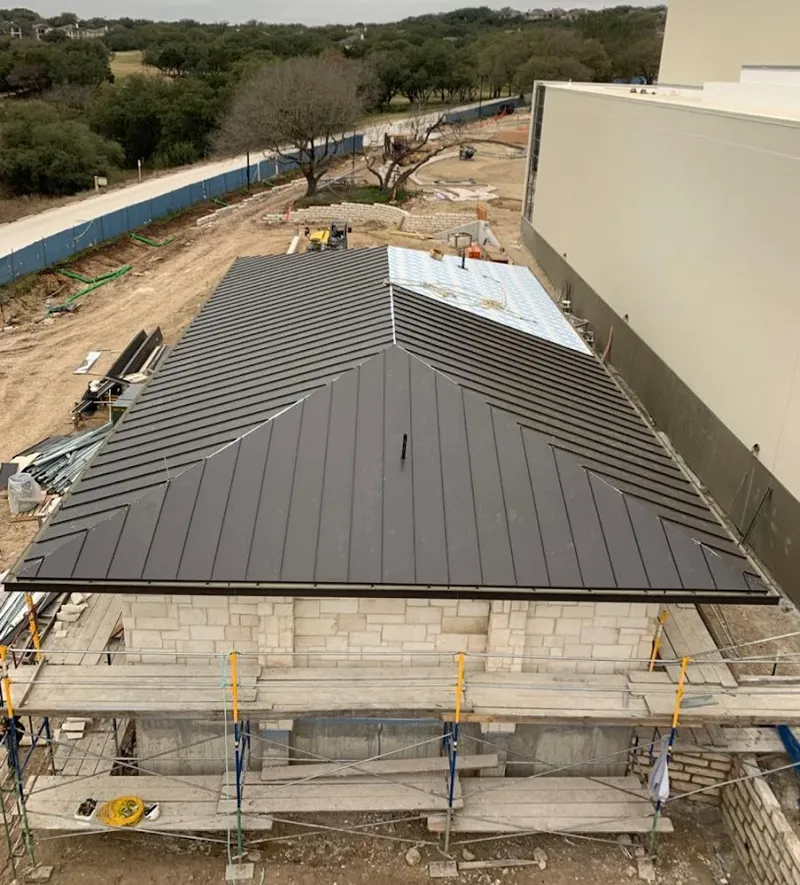 Metal roof new construction with scaffolding in Godley